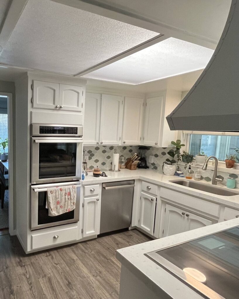 Before kitchen remodel with outdated white cabinets