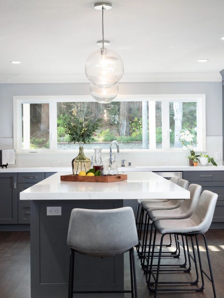 Kitchen island with lots of seating, huge windows and a ton of natural light