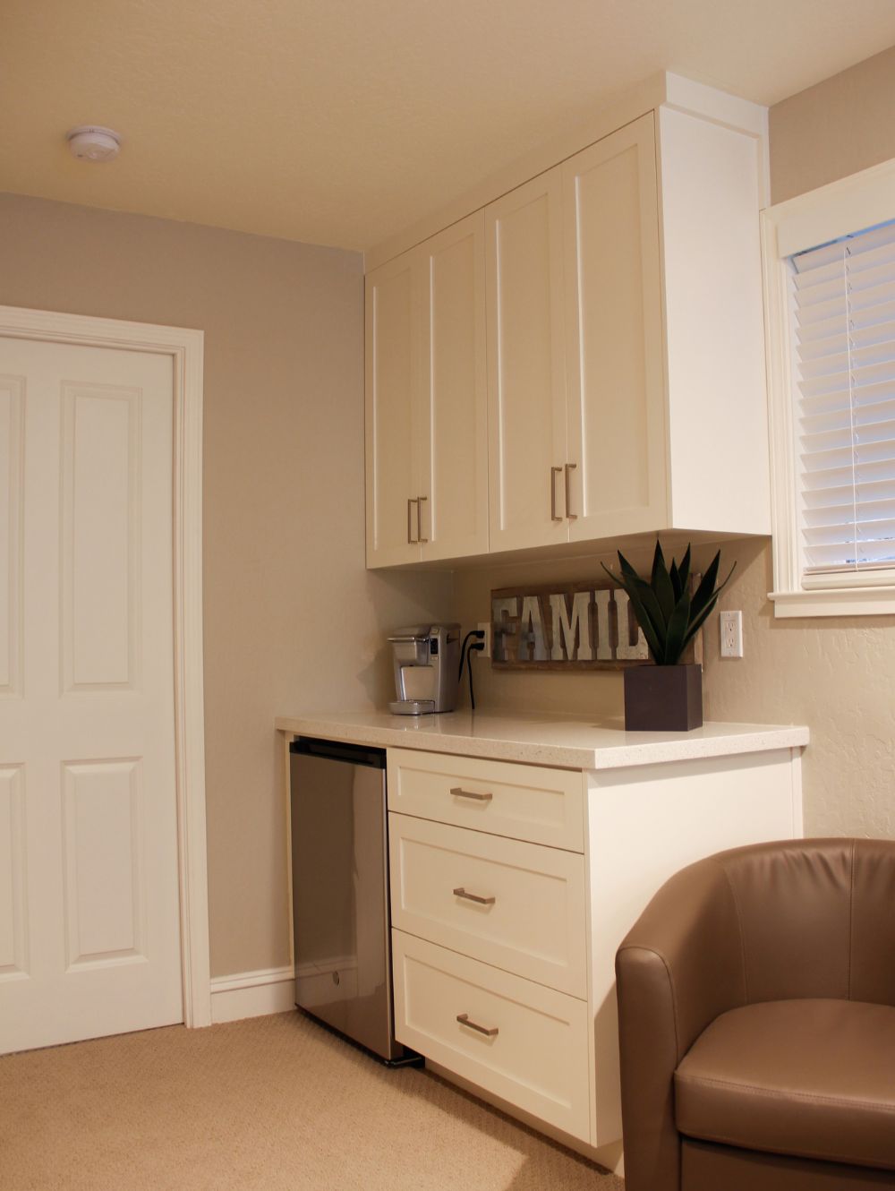 Kitchenette area with white cabinetry and clean lines