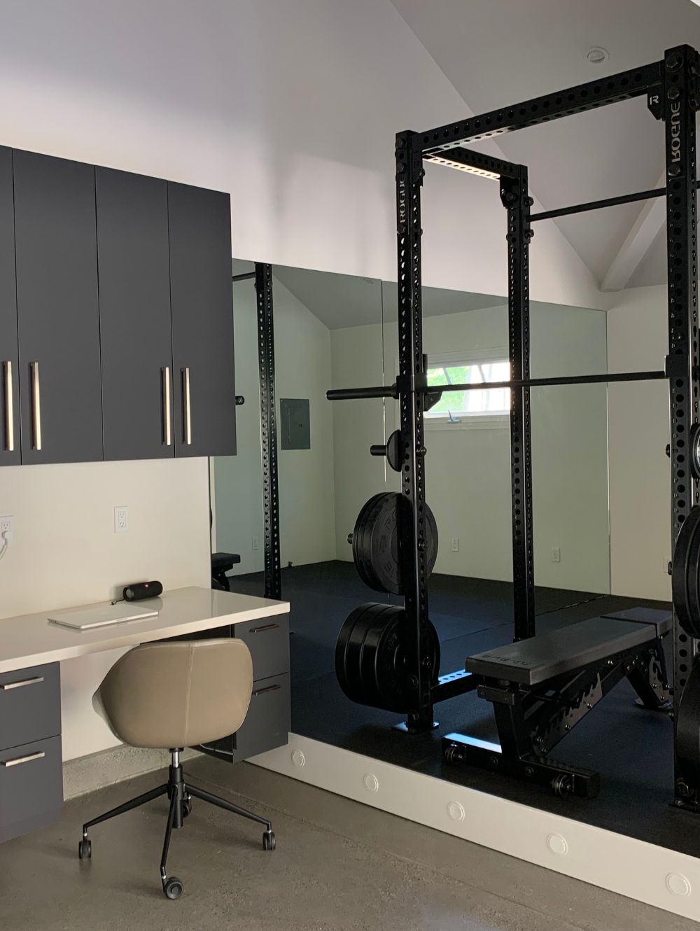 Weight lifting bench and desk area in a garage