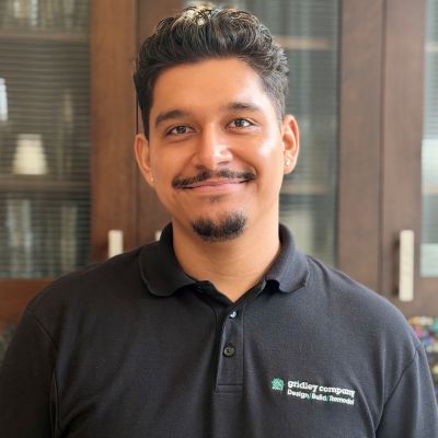 A smiling man wearing a black polo shirt with the Gridley Company logo.