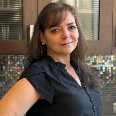 Gridley employee in front of a fun backsplash